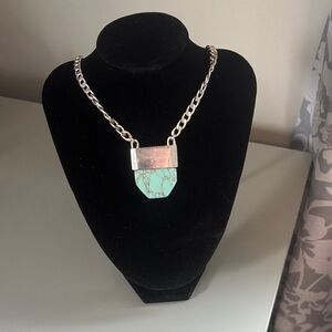 Unique long silver necklace with turquoise pendant.